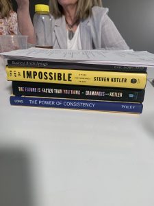 stack of books at genius exchange 2021